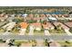 Aerial view of houses in a neighborhood by a lake at 620 Lakescene Dr, Venice, FL 34293