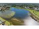 Aerial view of community lake and surrounding homes at 620 Lakescene Dr, Venice, FL 34293