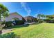 Landscaped backyard showcasing the home's exterior and pool at 620 Lakescene Dr, Venice, FL 34293