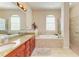 Elegant bathroom with granite countertops, double sinks, and a large tub at 620 Lakescene Dr, Venice, FL 34293