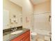 Bathroom with granite countertop, tub, and shower at 620 Lakescene Dr, Venice, FL 34293