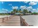 Wooden walkway leads to sandy beach with palm trees and beachfront restaurants at 620 Lakescene Dr, Venice, FL 34293
