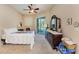 Bright bedroom with a double dresser and sliding doors leading to the pool area at 620 Lakescene Dr, Venice, FL 34293