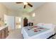 Cozy bedroom with a dresser and bathroom access at 620 Lakescene Dr, Venice, FL 34293