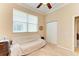 Well-lit bedroom featuring a sofa and double doors at 620 Lakescene Dr, Venice, FL 34293