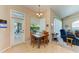 Bright breakfast nook features a table and chairs, access to the pool area, and view into the living room at 620 Lakescene Dr, Venice, FL 34293