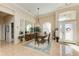 Bright dining room with tiled floors, large table, and access to the foyer at 620 Lakescene Dr, Venice, FL 34293