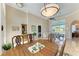 A well-lit dining area with a wooden table and access to the kitchen at 620 Lakescene Dr, Venice, FL 34293