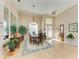 Elegant dining room featuring a large table, decorative rug, and natural light at 620 Lakescene Dr, Venice, FL 34293