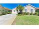 One-story home with a landscaped lawn and driveway at 620 Lakescene Dr, Venice, FL 34293