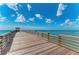 Long wooden pier extending over calm ocean water at 620 Lakescene Dr, Venice, FL 34293