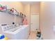 Laundry room with washer, dryer, and storage shelves at 620 Lakescene Dr, Venice, FL 34293