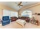 Relaxing living room with leather sofas, a coffee table, and ample natural light at 620 Lakescene Dr, Venice, FL 34293