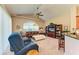 Spacious living room boasts a high ceiling, leather sofas, built-in shelving and a large TV at 620 Lakescene Dr, Venice, FL 34293
