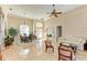 Spacious living room with tiled floors, comfortable seating and natural light at 620 Lakescene Dr, Venice, FL 34293