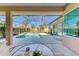Inviting pool area with screened enclosure and patio furniture at 620 Lakescene Dr, Venice, FL 34293