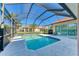 Inviting screened pool with tiled deck and surrounding landscaping at 620 Lakescene Dr, Venice, FL 34293