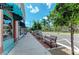 Relaxing sidewalk with benches, lined with shops and trees at 620 Lakescene Dr, Venice, FL 34293