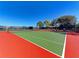 Well-maintained tennis courts with seating area at 620 Lakescene Dr, Venice, FL 34293