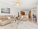 Spacious living room with light beige couches and a glass coffee table at 804 Amaryllis Ln, Venice, FL 34292