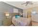 Comfortable bedroom with a queen bed, ceiling fan, and ensuite bathroom access at 13097 Rinella St, Venice, FL 34293