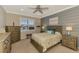 Cozy bedroom with a queen-size bed, ceiling fan, and ample closet space at 13097 Rinella St, Venice, FL 34293