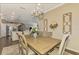 Spacious dining room with a large table, chandelier, and views into the kitchen at 13097 Rinella St, Venice, FL 34293