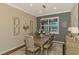 Bright dining room with a large table, chandelier, and access to backyard views at 13097 Rinella St, Venice, FL 34293