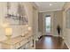 Light and bright entry hall with decorative console table and hardwood floors at 13097 Rinella St, Venice, FL 34293