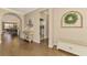 Bright and airy entryway with hardwood floors and a charming bench at 13097 Rinella St, Venice, FL 34293