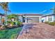 Beautiful home exterior with landscaping and paver driveway at 13097 Rinella St, Venice, FL 34293
