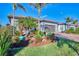 Landscaped yard with tropical plants and paver driveway at 13097 Rinella St, Venice, FL 34293