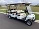 Six-passenger golf cart with tan seats and white body at 13097 Rinella St, Venice, FL 34293