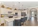 Modern kitchen with white cabinets, island, and hardwood floors at 13097 Rinella St, Venice, FL 34293