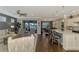 Open floor plan boasts a spacious kitchen with island and stainless steel appliances, overlooking the living room with cozy seating at 13097 Rinella St, Venice, FL 34293