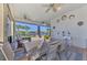 Spacious screened lanai with lake view, dining table, and comfortable seating at 13097 Rinella St, Venice, FL 34293