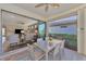 Outdoor screened patio with seating and view of backyard at 13097 Rinella St, Venice, FL 34293