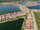 Aerial view of a lakefront home in a luxury community at 254 Toscavilla Blvd, Nokomis, FL 34275