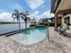 Stunning pool and patio area overlooking a lake at 254 Toscavilla Blvd, Nokomis, FL 34275