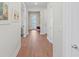 Bright and spacious hallway with wood-look flooring at 26056 Seastone Dr, Englewood, FL 34223