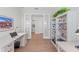 Bright home office features built-in shelving and hardwood floors at 26056 Seastone Dr, Englewood, FL 34223