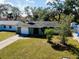 Quaint green house with driveway and nicely landscaped yard at 1323 Karen Dr, Venice, FL 34285