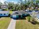 Charming green house with a one-car garage and well-maintained lawn at 1323 Karen Dr, Venice, FL 34285