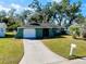 House exterior view with green walls and a white garage door at 1323 Karen Dr, Venice, FL 34285