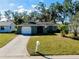 Single story home with a green exterior and a well-manicured lawn at 1323 Karen Dr, Venice, FL 34285