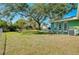 Large grassy backyard with mature shade trees at 1323 Karen Dr, Venice, FL 34285