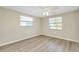 Spacious bedroom with light walls, wood flooring, and ceiling fan at 1323 Karen Dr, Venice, FL 34285