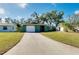 Green house with a white garage door and landscaped front yard at 1323 Karen Dr, Venice, FL 34285