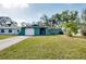 Green house exterior with white garage door and landscaping at 1323 Karen Dr, Venice, FL 34285