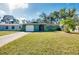 House exterior featuring a green facade and a spacious lawn at 1323 Karen Dr, Venice, FL 34285